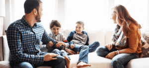 Happy Family Talking On Couch During Holidays 1024x469